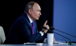 Russian President Vladimir Putin attends his annual end-of-year news conference in Moscow, Dec. 23, 2021. (Sputnik/Mikhail Metzel/Pool via Reuters)