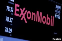 FILE - The logo of ExxonMobil Corporation is shown on a monitor above the floor of the New York Stock Exchange in New York, Dec. 30, 2015.