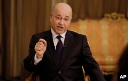 Iraq's President Barham Salih speaks during an interview with The Associated Press in Baghdad, Iraq, March 29, 2019.