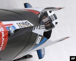 FILE - United States' Elana Meyers with brakeman Lauryn Williams compete in a bobsled designed by BMW Designworks USA in the women's bobsled World Cup event in Lake Placid, N.Y., Dec. 14, 2013.