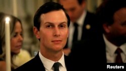FILE - White House senior adviser Jared Kushner listens as dent Trump speaks at a dinner to honor evangelical leadership at the White House in Washington, Aug. 27, 2018.