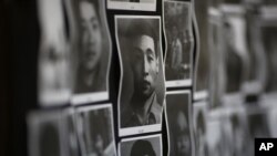 FILE - Portraits of victims of the June 4, 1989 bloodshed are displayed at the June 4 Memorial Museum run by pro-democracy activists in Hong Kong.