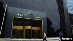 People walk outside the building where the offices of Brazilian construction firm Odebrecht are in Buenos Aires, Argentina, May 24, 2017. 