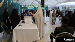 An Iranian votes at a polling station in the presidential election to choose a successor to Ebrahim Raisi following his death in a helicopter crash, in Tehran on June 28, 2024. (West Asia News Agency via Reuters)