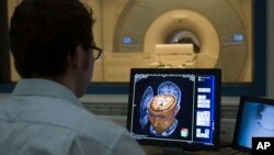 Sebastian Rieger, physicist MRI, makes a demonstration of the new 3 Tesla MRI (Magnetic Resonance Imaging) at the Brain and Behaviour Laboratory in Geneva, Switzerland, Dec. 8, 2008. (AP Photo/KEYSTONE/Salvatore Di Nolfi)