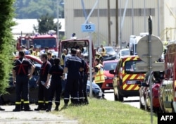 French police and firefighters gather at the entrance of the U.S.-based Air Products company in Saint-Quentin-Fallavier, near Lyon, central eastern France, June 26, 2015.