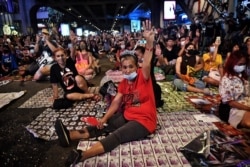 Pro-democracy protesters flash the three-finger salute during a 'Bad Student' rally in Bangkok, Thailand, Nov. 21, 2020.