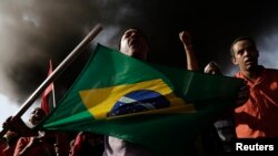 Members of Brazil's Homeless Workers' Movement block a road near Sao Paolo’s World Cup stadium to protest spending on the soccer tournament May 15, 2014.
