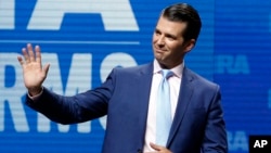 FILE - Donald Trump Jr. waves from the stage at the National Rifle Association in Dallas, May 4, 2018.