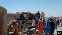 Taliban fighters patrol inside the city of Farah, capital of Farah province, southwest Afghanistan, Aug. 11, 2021.