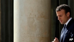 French President Emmanuel Macron accompanies Senegal's President Macky Sall (not seen) after their meeting at the Elysee Palace in Paris, June 12, 2017.