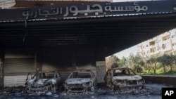 Burned-out cars remain in an open garage following the recent wave of violence between Syrian security forces and gunmen loyal to former President Bashar Assad, as well as subsequent sectarian attacks, Jableh, Syria, March 10, 2025.