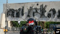 An Iraqi security forces vehicle arrives near the site of days of protests in Tahrir square, central Baghdad, Iraq, Oct. 5, 2019, after a curfew was lifted in the Iraqi capital Saturday.