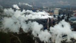 FILE PHOTO - In this Nov. 28, 2019 photo, smoke and steam rise from a coal processing plant in Hejin in central China's Shanxi Province.