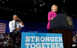 President Barack Obama pretends to wipe away tears as Democratic presidential candidate Hillary Clinton talks about Malia Obama graduating college, during a campaign event at the Charlotte Convention Center in Charlotte, N.C., July 5, 2016.