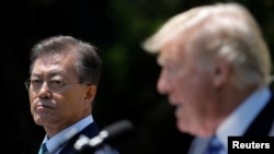 South Korean President Moon Jae-in and U.S. President Donald Trump, right, deliver a joint statement from the Rose Garden of the White House in Washington, June 30, 2017.