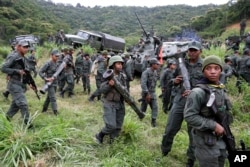 Soldiers break ranks after standing in formation behind Admiral Remigio Ceballos, chief of staff of the Armed Forces Strategic Operational Command, during a news conference to provide details of military drills that are being prepared in response to President Donald Trump's warning of possible military action, at Fort Tiuna, Caracas, Venezuela, Aug. 25, 2017.