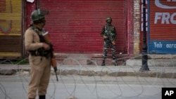 Indian paramilitary soldiers stand guard on a deserted road in Srinagar, Indian controlled Kashmir, Wednesday, May 6, 2020. Government shut down cellphone and nd mobile internet services after anti-India protests, officials, and residents said. (AP Photo/ Dar Yasin)