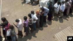 FILE – Voters line up at a polling station in Kampala, Uganda, in February 2011, as they wait to cast their ballot. 