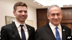 FILE - Israeli Prime Minister Benjamin Netanyahu, right, and his son Yair pose for a photo in Tel Aviv, Israel, Jan. 23, 2020.