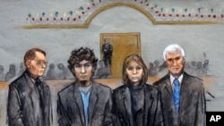 In this courtroom sketch, Dzhokhar Tsarnaev, second from left, is depicted standing with his defense attorneys William Fick, left, Judy Clarke, second from right, and David Bruck, right, as the jury presents its verdict, April 8, 2015.