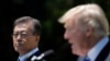 FILE - South Korean President Moon Jae-in and U.S. President Donald Trump, right, deliver a joint statement from the Rose Garden of the White House in Washington, June 30, 2017.