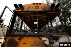 A school bus burned by the Eaton Fire stands on a street in Altadena, California, Jan.10, 2025.