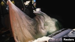 Sailors assigned to Explosive Ordnance Disposal Group 2 recover a suspected Chinese high-altitude surveillance balloon that was downed by the United States over the weekend off the coast of Myrtle Beach, South Carolina, Feb. 5, 2023.