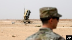 FILE - A member of the U.S. Air Force stands near a Patriot missile battery at the Prince Sultan air base in al-Kharj, central Saudi Arabia, Feb. 20, 2020. 