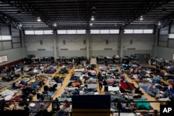 FILE - Ukrainian refugees wait in a gymnasium on April 5, 2022, in Tijuana, Mexico.