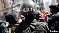 Security forces stand guard in front of the Presidential Palace during a protest in La Paz, Bolivia, Oct. 29, 2019. 