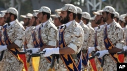 FILE - Members of Iran's Islamic Revolutionary Guard Corps march just outside Tehran during an armed forces parade, Sept. 22, 2011. 