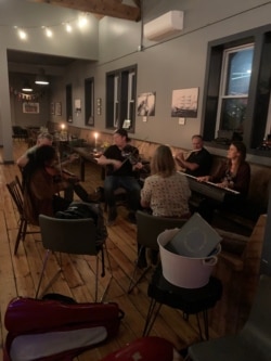 Popular PEI musical group Vishten plays with family as an afterparty to the Route 11 music festival in PEI, which has largely been spared by the pandemic. (Jay Heisler/VOA)
