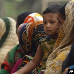 A woman waits in line to buy subsidized rice in Bangladesh.