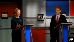FILE - Carly Fiorina speaks as Rand Paul listens during the Republican presidential debate at the Milwaukee Theatre, Nov. 11, 2015, in Milwaukee, Wisconsin.