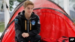 FILE - Parker Liautaud, 19, from the U.S., poses for a photo outside of a tent, during a publicity photo shoot for the launch of the Willis Resilience Expedition, in London, Sept. 30, 2013. 