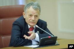 Crimean Tatar leader Mustafa Dzhemilev, takes part in the Ukrainian Cabinet session in Kiev, Ukraine, Monday, Nov. 23, 2015.