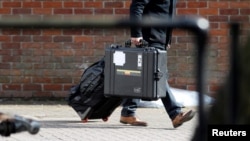 FILE - An inspector from the Organization for the Prohibition of Chemical Weapons (OPCW) arrives to begin work at the scene of the nerve agent attack on former Russian spy Sergei Skripal, in Salisbury, Britain, March 21, 2018. An OPCW team will begin collecting samples April 14, 2018, at the site of an alleged chemical weapons attack in Douma, Syria.