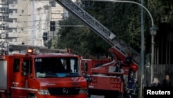 Firemen work at the area where an explosive device went off outside Greece's labour ministry in Athens, Greece, Feb. 3, 2024. 