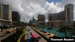 FILE - Traffic flows past gaming resorts at Cotai Strip in Macau, May 15, 2018. 
