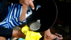 An illegal gold miner works with mercury in Nova Olinda, Brazil, Nov. 26, 2021.