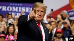 President Donald Trump arrives for a campaign rally at Florida State Fairgrounds Expo Hall in Tampa, Fla., July 31, 2018.
