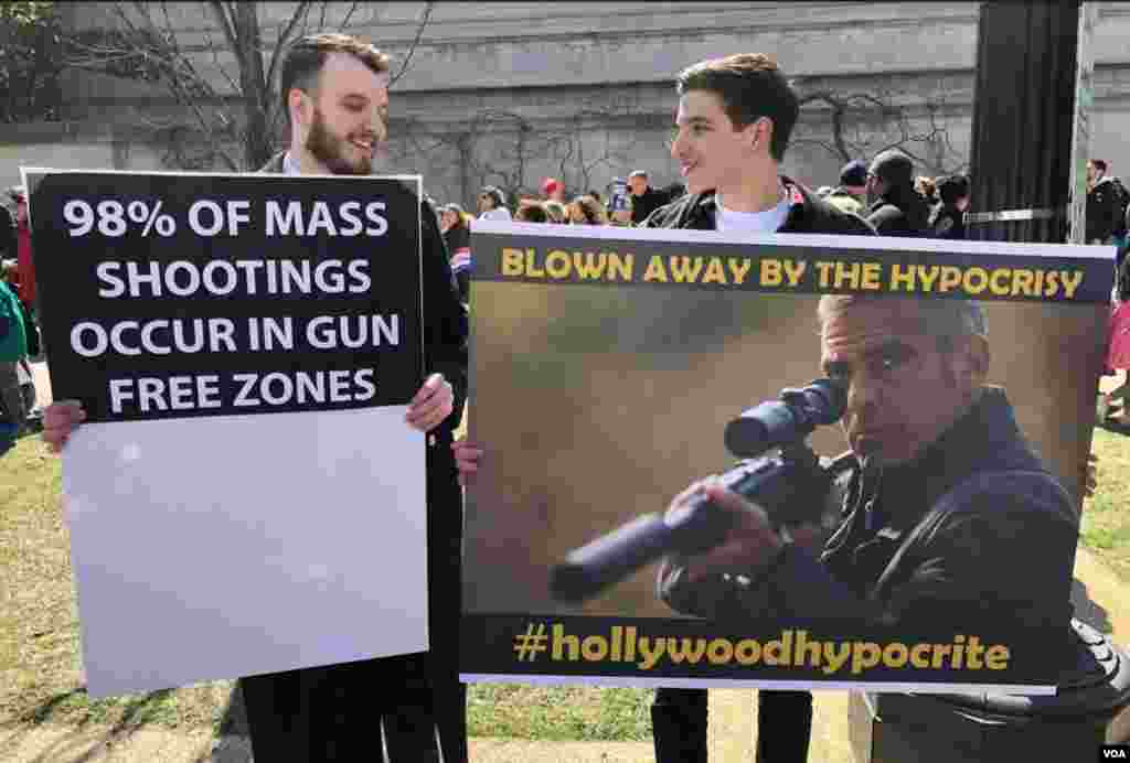 Anti-gun control protesters hold signs at the &quot;March for Our Lives&quot; rally in Washington, March 24, 2018. (G. Tobias/VOA)