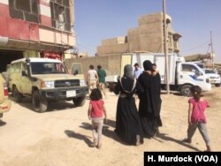 Umm Saja and her family arrive at a field hospital in Mosul, Iraq, June 21, 2017, after fleeing their home in IS-territory only an hour before. Her daughter, Saja, 1, is so thin from lack of food that doctors have difficulty finding veins to inject nutrients into her.