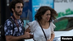 Police (not pictured) evacuate people after a van crashed into pedestrians near the Las Ramblas avenue in central Barcelona, Spain, Aug. 17, 2017.