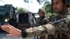 Afghan National Army soldiers search vehicles at a checkpoint in the city of Jalalabad on Aug. 1, 2018. Afghanistan ramped up security in Jalalabad on August 1, a day after militants stormed a government office in Nangarhar province.