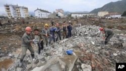 FILE - Workers recover cement blocks from flood-damaged areas in Onsong, North Hamgyong Province, North Korea, Sept. 16, 2016.
