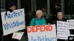FILE - In this June 27, 2019, photo, whistleblower supporters demonstrate in Canberra, Australia, after a former army lawyer was charged with leaking documents alleging misconduct in Afghanistan.