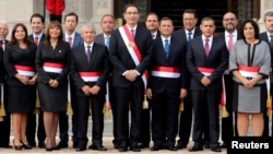 Peru's President Martin Vizcarra, center, and new ministers pose for a picture during their swearing-in ceremony at the government palace in Lima, Peru, April 2, 2018. 