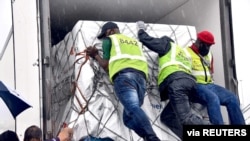 Workers load South Africa's first COVID-19 vaccine as they arrive at OR Tambo airport in Johannesburg, Feb. 1, 2021. (Credit: Elmond Jiyane for GCIS/Handout)
